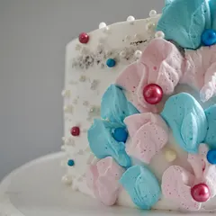 This is a close-up of the delicate, hand-piped floral work on one of my baby shower cakes. I use soft buttercream to create petal-like textures, accented with sugar pearls for a touch of elegance.
