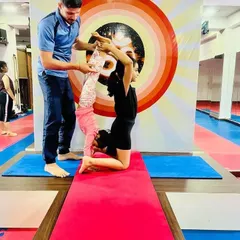 An instructor provides gentle support as our youngest yogis explore partner poses. Safety and encouragement are the foundations of our children's classes.