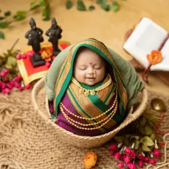 Our 'Chotishi Rakhumai' newborn session features this little one dressed in a traditional Marathi-style saree wrap, complete with jewelry, capturing a moment of pure cultural heritage.