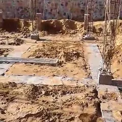 The foundation and column footings taking shape at our Orian Farmhouse site in Manesar. This image captures the crucial stage where the structural skeleton of the building begins to emerge from the ground.