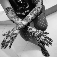 A stunning bridal henna design in a flowing, spaced-out style. I included the bride's name, Afreen, on the back of her hand. This black and white photo really highlights the line work.