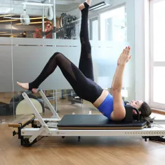 A beautiful demonstration of a single-leg bridge on the reformer, an exercise that targets the glutes, hamstrings, and core while improving stability.