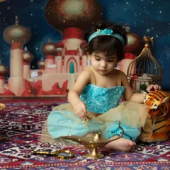 A moment of wonder with the magic lamp. The detailed props and vibrant backdrop bring this beloved fairytale to life for a truly unique photoshoot.