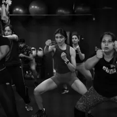 Intensity and focus captured during a Strong by Zumba class. The powerful stances and synchronized movements show how this workout builds both physical and mental toughness.