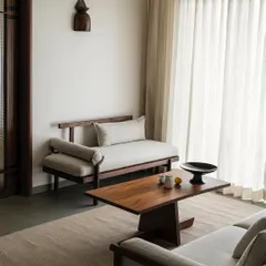 A closer look at the living area in Apartment 1005, where custom-designed teak wood seating creates a warm and inviting atmosphere. The design focuses on clean lines and natural textures, achieving a look that is both minimal and luxurious.