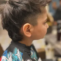 A cool and messy-but-stylish mullet for a young client. This is a fun, modern kid's haircut that has a lot of personality.