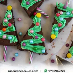 A close-up of my Christmas tree brownies. These are cut from a sheet of my classic eggless chocolate brownie and decorated with festive green frosting and candy ornaments, bringing a bit of holiday cheer.