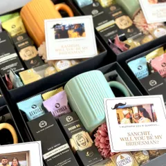 I mustache you a question! These groomsmen proposal boxes include fun, personalized cards, grooming essentials from The Man Company, a colorful mug, and Ferrero Rocher.