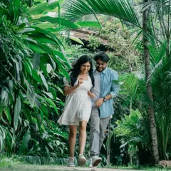 A casual stroll through a lush, tropical pathway in Bangalore. This photo captures the couple in motion, creating a dynamic and natural pre-wedding portrait that feels authentic and unposed.