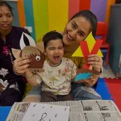 Even when a child is tearful, the creative process continues with the support of their parent. This real moment at our Rajouri Garden center shows a mother and child with their paper crafts, reminding us that learning has its ups and downs.