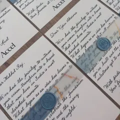 A handwritten note of appreciation goes a long way. These notecards for a private corporate event for Accel feature classic black ink calligraphy on white paper, elegantly finished with a blue vellum band and a custom wax seal.