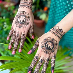 A striking design with a bold elephant motif inside a central mandala, complemented by detailed finger patterns and a traditional wristband.