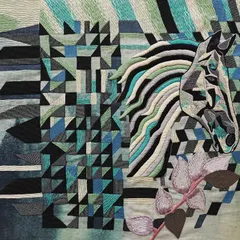 This is the "Mare in her field," a companion piece to the horse tapestry. The cool palette of blues and greens in the embroidery reflects her calm and royal nature. This work celebrates the sensitive yet strong leadership qualities of female animals.