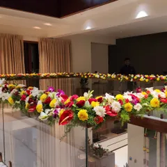 A beautiful floral decoration for a glass railing inside a house. The colorful flowers add a festive touch to the entire space.