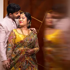 An artistic couple portrait using a motion blur effect on the reflection, creating a dynamic and romantic image for their Gruha Pravesha.