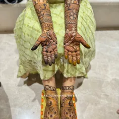 A complete bridal look from hands to feet. The arm henna is packed with custom story elements, while the foot henna features matching traditional designs.