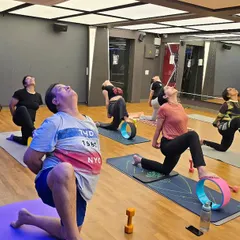 In my studio classes, we often use props like the yoga wheel to explore poses more deeply and safely. Here, my students are in a heart opening backbend, using the wheel to support their spine, enhance flexibility, and build core strength.