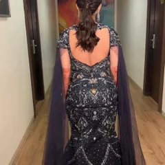 A view from the back showcasing a unique and textured ponytail. The intricate twists and braids add a high-fashion element to this cocktail look.