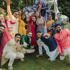 A fun and energetic group photo during a wedding carnival. Everyone is striking a pose and having a great time, perfectly capturing the festive and playful vibe of the event.