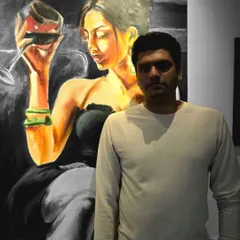 Artist Sayooj, a UX designer by profession, is pictured with his stunning oil portrait of a woman with a glass of wine. His passion for art is evident in his beautiful and evocative paintings of women.
