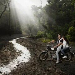 I love creating a moody, cinematic feel. Here, we used the misty forest roads of Uttarakhand and a classic motorcycle to capture a moment of adventure and romance, with dramatic light rays breaking through the trees.