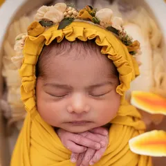 A close up of this beautiful baby, showing the delicate features and peaceful expression that make newborn portraits so special. I use specific lighting techniques to highlight every tiny detail, from eyelashes to tiny fingers.