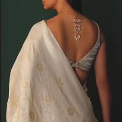 The beauty is in the details. This shot highlights a stunning carved necklace worn with a backless blouse and a handwoven saree, showcasing how accessories can elevate an entire look.