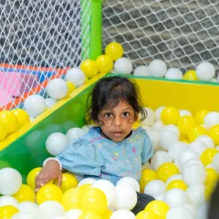 A moment of quiet contemplation amidst the fun. Even in a dynamic play area, children find their own space, showcasing their growing independence and comfort in the environment we've created.