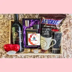 A sophisticated birthday hamper for him, combining a bottle of premium non-alcoholic wine with a stylish hip flask set, gourmet chocolates, and grooming essentials. It's the perfect blend of classic and modern.