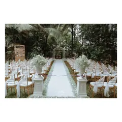 A wider view of the serene white-masked pathway, creating a beautiful and dramatic entrance for the bride.