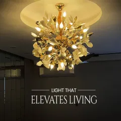 This gold chandelier with a leaf-like design is a perfect centerpiece for a living room. It provides a warm, inviting glow and its design adds a touch of nature-inspired elegance. It is installed here within a circular false ceiling to make it stand out.