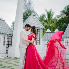 A pop of color for a vibrant love. This magenta trail gown looks incredible against the unique white architecture, making your pre-wedding photos stand out.