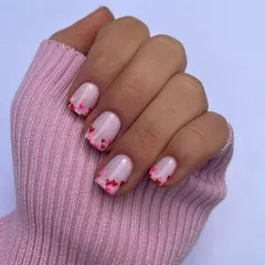 A fun twist on a French manicure, with tiny pink and red hearts creating a gradient effect at the tips. This design is playful, cute, and expertly detailed.