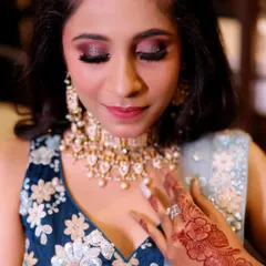A close-up of my engagement makeup artistry. This look features a bold, glittery smokey eye with winged liner and full lashes, paired with a soft lip color to balance the dramatic eyes.