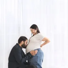 The connection between partners is a beautiful part of the pregnancy journey. We create a comfortable space for these tender, unscripted moments, like a gentle kiss to the baby bump.