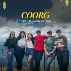 A group of six women stands smiling on a viewpoint in Coorg, the Scotland of India. This is what friendship and adventure in the hills look like.
