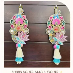 This pair of Krishna and Lotus Shubh Laabh hangings is designed to invite blessings and prosperity. The vibrant colors, sequin work, and tassel details make them a perfect addition to your puja space or as a thoughtful Diwali gift.