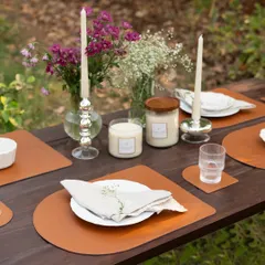 An elegant outdoor table setting featuring our classic taper candles in stylish glass holders. Paired with our jar candles, they create a layered and magical atmosphere perfect for any gathering.