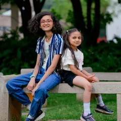 A classic sibling portrait taken on a park bench. I guide my subjects into poses that feel natural, allowing their personalities to shine through.