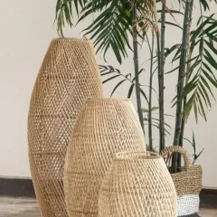 Add a touch of natural elegance to your home with our set of three handwoven rattan and bamboo floor vases. Their intricate texture and organic shape make them a stunning focal point, perfect for displaying dried botanicals or standing alone as sculptural art.
