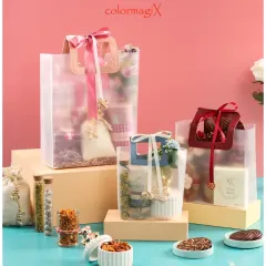 Our modern and stylish PVC transparent hamper bags. These bags offer a contemporary look while showcasing the beautiful gifts inside, finished with elegant ribbons in various colors to suit any occasion.