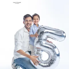 Celebrating a fifth birthday in the studio. Using props like this giant number balloon adds a fun, celebratory touch to your child's milestone photoshoot.