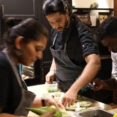 The team working in sync to assemble canapés. Every member plays a crucial role in bringing the menu to life.