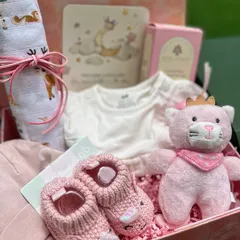 A wider view of the celestial hamper, showing how I layer items like the swaddle, clothing, and toys to create a full and luxurious gift.