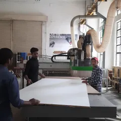 Our students learn to operate advanced CNC machinery, a critical skill in modern woodworking. Here, they are preparing a large panel for automated cutting, bridging traditional craft with digital fabrication.