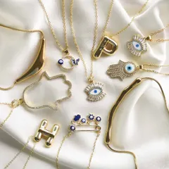 Your cart looks empty. This flat lay shows off a variety of my best-selling necklaces, from the safety pin charm to the jumbo hamsa and balloon initial designs.