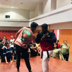 A live demonstration during our workshop at NIFT. We believe in interactive learning, showing students how to apply techniques against a resisting partner in a controlled environment.
