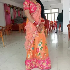 A beautiful client dressed in a bright floral lehenga for a wedding celebration. The colors look so vibrant on her.