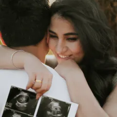 Sharing the secret. This close-up shot of the couple with their sonogram pictures is an intimate and emotional way to announce a pregnancy.