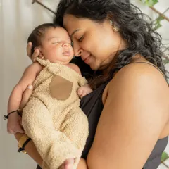 A mother's love in its purest form. This quiet, intimate moment between a mom and her sleeping newborn is a powerful and timeless image of their unbreakable bond.